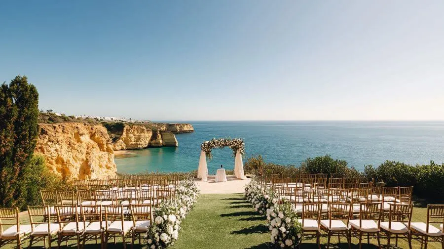 Clifftop ceremony overlooking a turquoise cove at midday